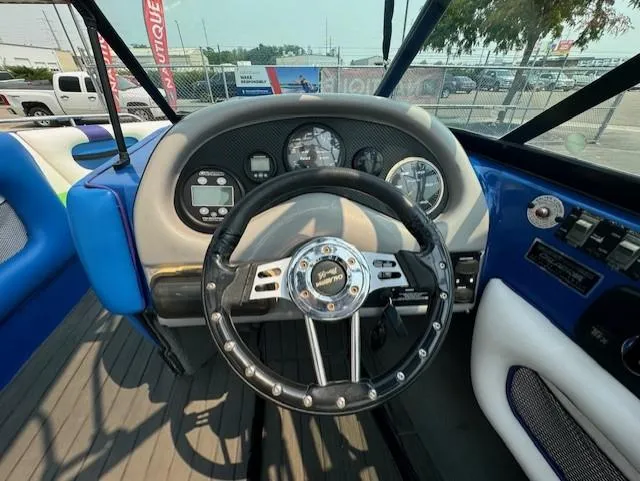 Slide: The Image of 2005 Calabria Cal Air Pro-V boat dashboard with steering wheel and gauges. - 19