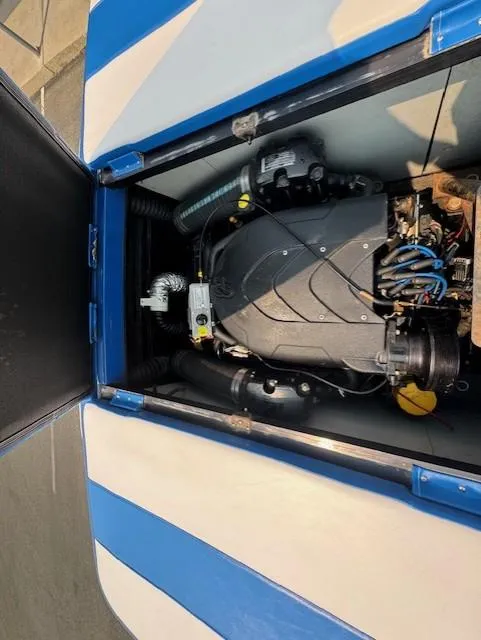 Slide: The Image of 2005 Calabria Cal Air Pro-V engine compartment with blue and white cover. - 20