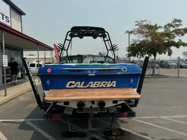 Slide: The Image of 2005 Calabria Cal Air Pro-V boat, blue, parked in a lot near a building. - 4