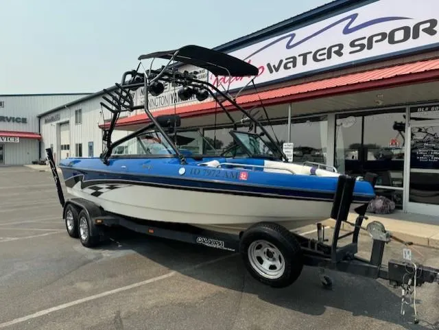 Slide: The Image of 2005 Calabria Cal Air Pro-V boat on trailer outside a water sports store. - 9