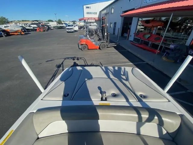 Slide: The Image of 2006 Centurion Air Warrior Elite C-4 boat in a dealership lot with forklift nearby. - 12