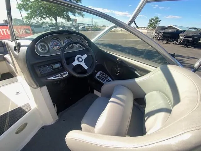 Slide: The Image of 2006 Centurion Air Warrior Elite C-4 boat interior with steering wheel and dashboard controls. - 13