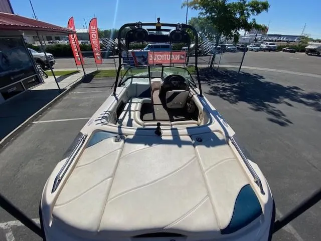 Slide: The Image of 2001 Nautique Super Air Nautique 210 boat, parked outdoors, showcasing interior and steering wheel. - 11