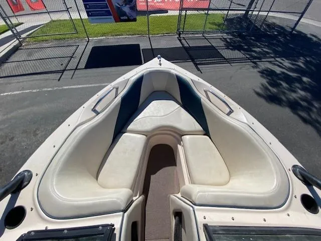 Slide: The Image of 2001 Nautique Super Air Nautique 210 boat interior with white seating and open bow design. - 12