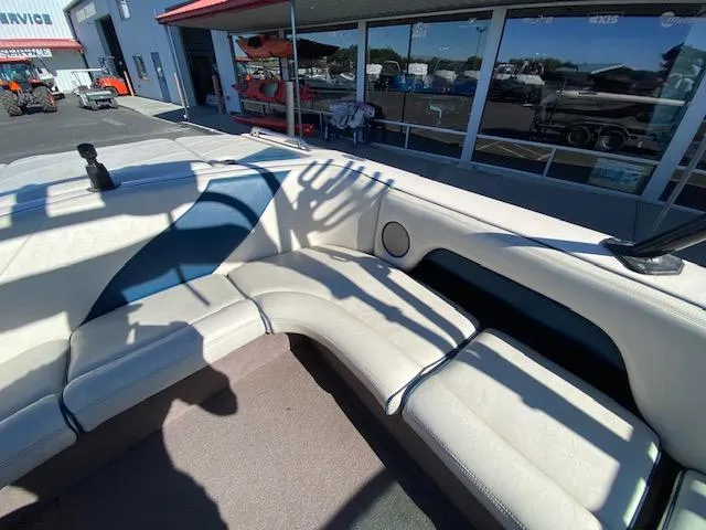 Slide: The Image of 2001 Nautique Super Air Nautique 210 boat interior with white seating and blue accents. - 15