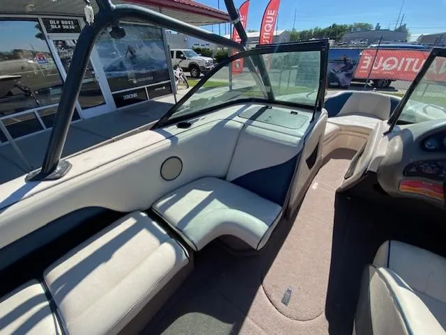 Slide: The Image of 2001 Nautique Super Air Nautique 210 interior with seating and dashboard view. - 16