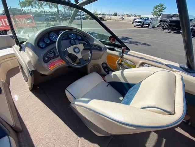 Slide: The Image of 2001 Nautique Super Air Nautique 210 boat interior with steering wheel and dashboard controls. - 17
