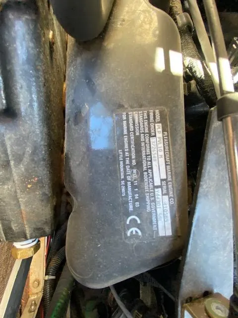 Slide: The Image of Close-up of a 2001 Nautique Super Air Nautique 210 engine component with label details. - 20