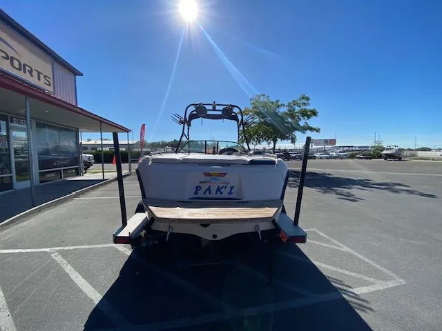 Slide: The Image of 2001 Nautique Super Air Nautique 210 boat parked outdoors under bright sun. - 4
