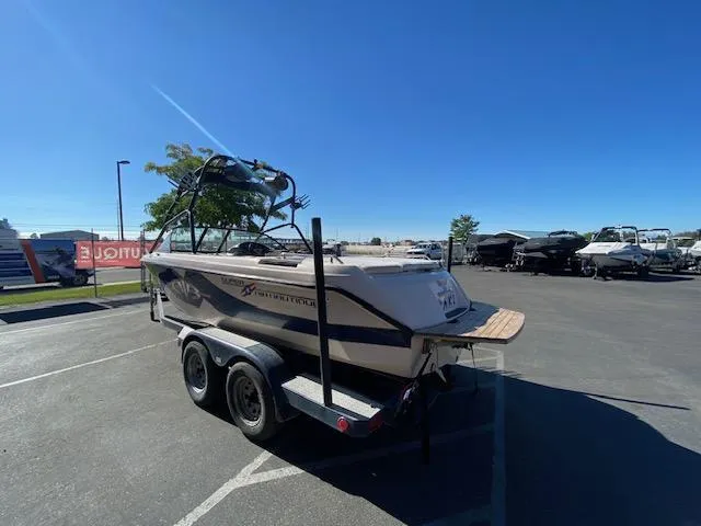 Slide: The Image of 2001 Nautique Super Air Nautique 210 boat on trailer in parking lot. - 5