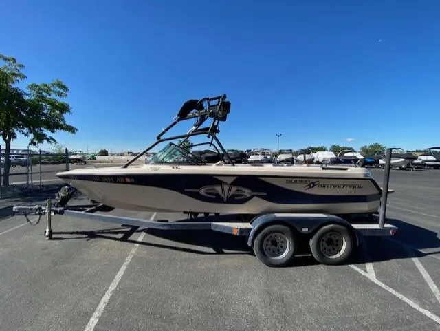 Slide: The Image of 2001 Nautique Super Air Nautique 210 boat on trailer in parking lot. - 6