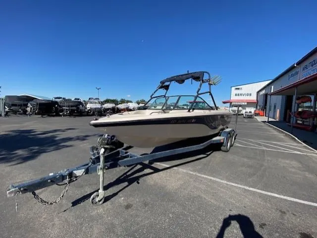 Slide: The Image of 2001 Nautique Super Air Nautique 210 boat on trailer in parking lot. - 7