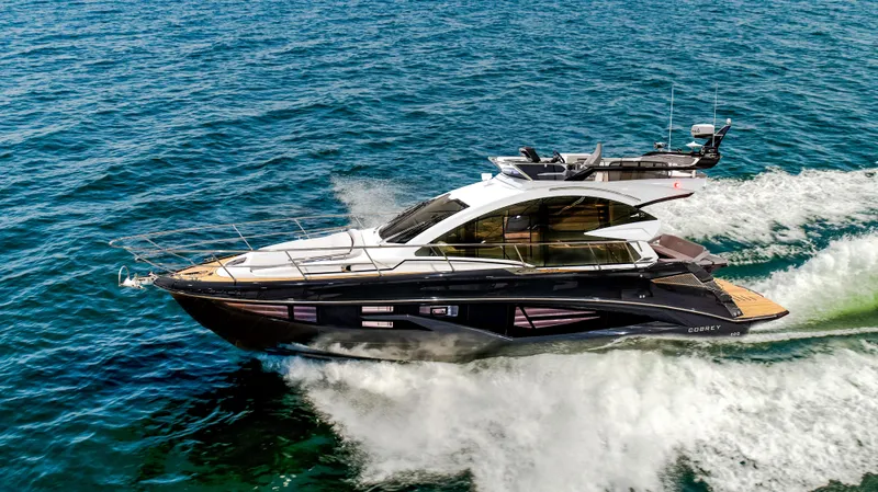 Slide: The Image of 2026 Cobrey 45 Fly yacht cruising on open water. - 2
