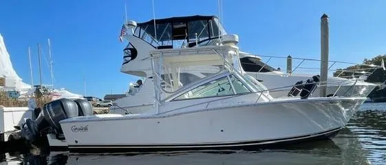 Slide: The Image of 2013 Carolina Classic 25 Express boat docked in marina, side view. - 1