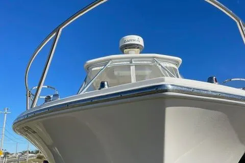 Slide: The Image of 2013 Carolina Classic 25 Express boat with Garmin radar against clear blue sky. - 15