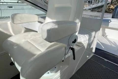 Slide: The Image of 2013 Carolina Classic 25 Express boat interior with white captain's chair. - 5