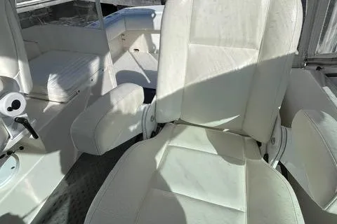 Slide: The Image of 2013 Carolina Classic 25 Express boat interior with white seating and helm area. - 6