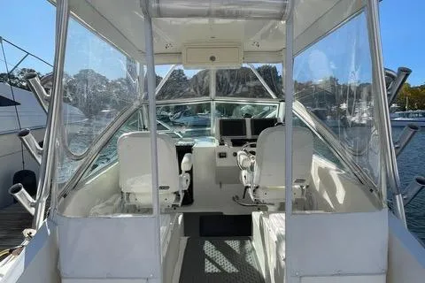 Slide: The Image of 2013 Carolina Classic 25 Express boat interior with helm and seating. - 7