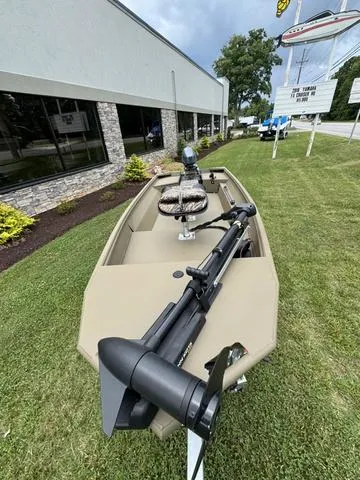 Slide: The Image of 2024 G3 16 FL boat with camo seats and motor, parked on grass. - 4