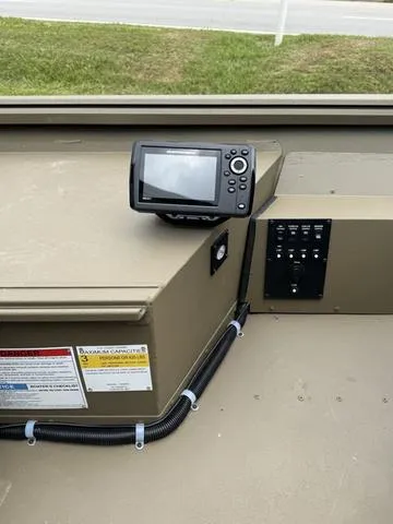 Slide: The Image of 2024 Yamaha outboard motor on G3 16 FL boat, parked on grass. - 7