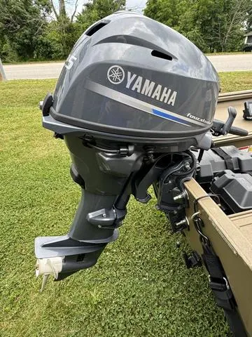 Slide: The Image of 2024 G3 16 FL boat with 25 HP outboard motor on grassy area. - 8