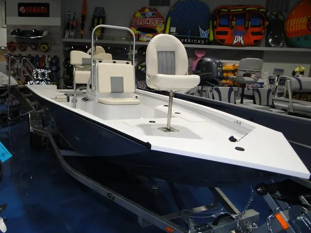 Slide: The Image of 2024 G3 Bay 18 GX boat cruising on a lake with a person at the helm. - 2