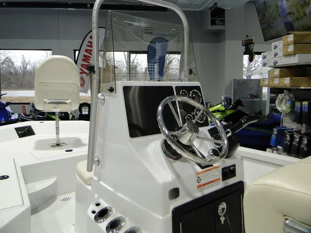 Slide: The Image of 2024 G3 Bay 18 GX boat with T-top and seating, displayed on a trailer. - 7