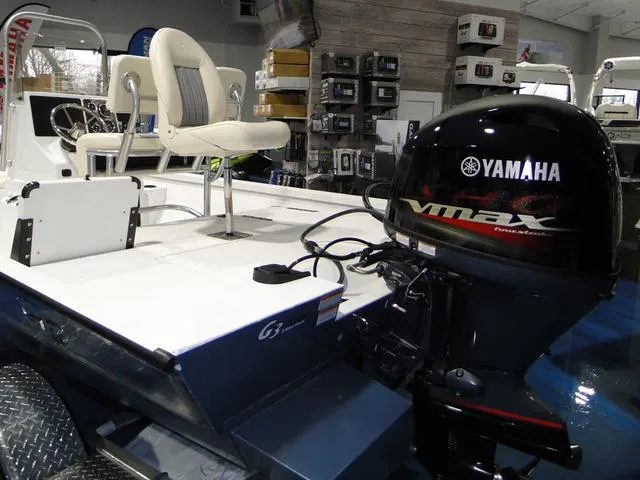 Slide: The Image of 2024 G3 Bay 18 GX boat interior with steering console and seating. - 8