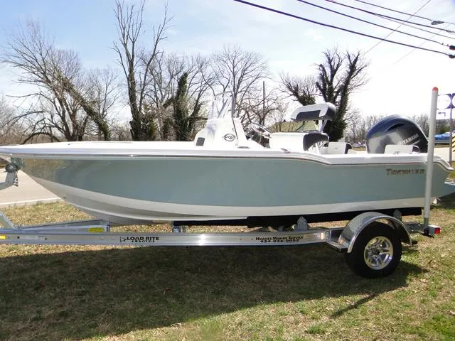 Slide: The Image of 2024 Tidewater 180 CC Adventure boat on trailer, parked outdoors. - 1