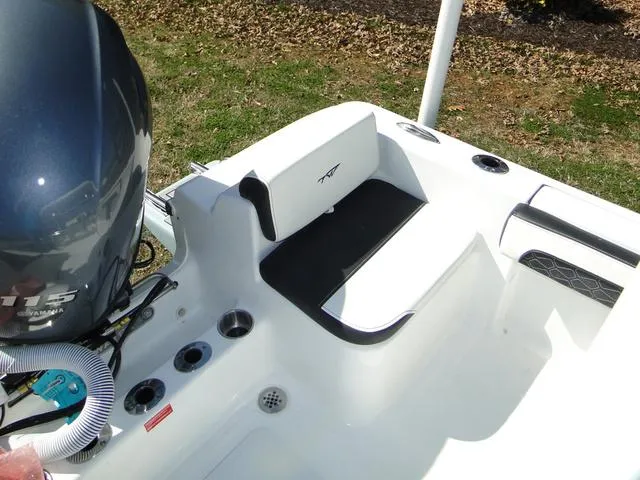Slide: The Image of 2024 Tidewater 180 CC Adventure boat interior with seating and motor detail. - 10