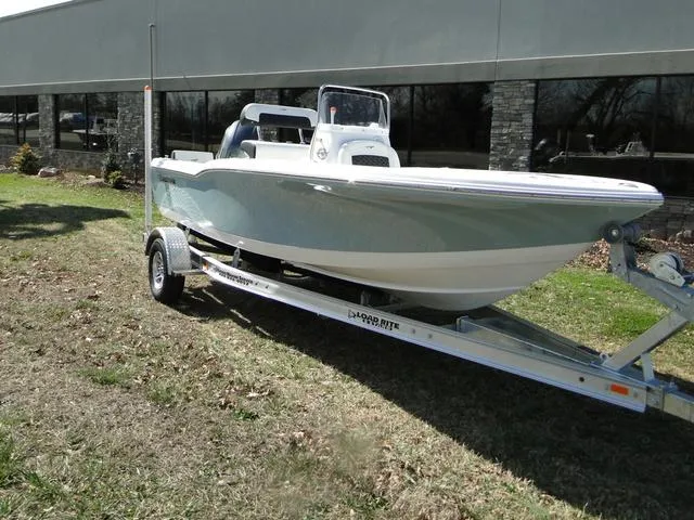 Slide: The Image of 2024 Tidewater 180 CC Adventure boat on trailer, parked outdoors. - 2