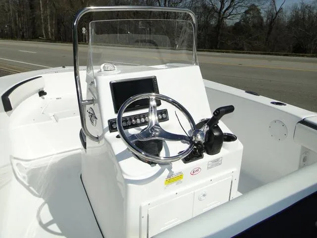 Slide: The Image of 2024 Tidewater 180 CC Adventure boat console with steering wheel and controls. - 5