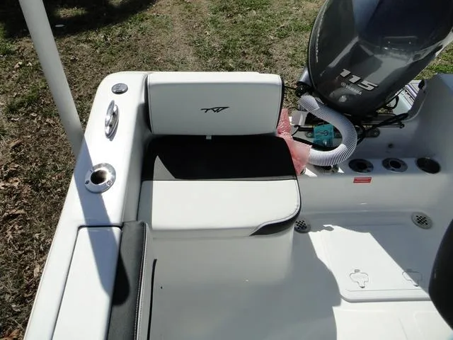 Slide: The Image of 2024 Tidewater 180 CC Adventure boat interior with seating and motor. - 9