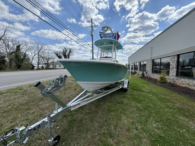 Slide: The Image of 2024 Sportsman Open 212 boat on trailer, parked outdoors under cloudy sky. - 10