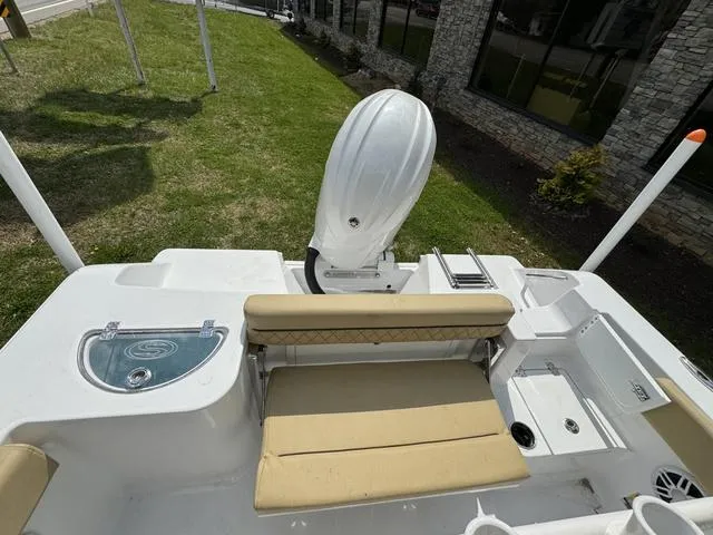 Slide: The Image of 2024 Sportsman Open 212 boat with seating and motor, displayed outdoors. - 14