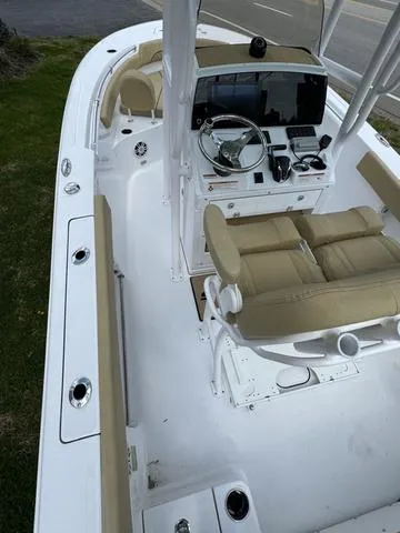 Slide: The Image of 2024 Sportsman Open 212 boat interior with beige seating and modern dashboard. - 15