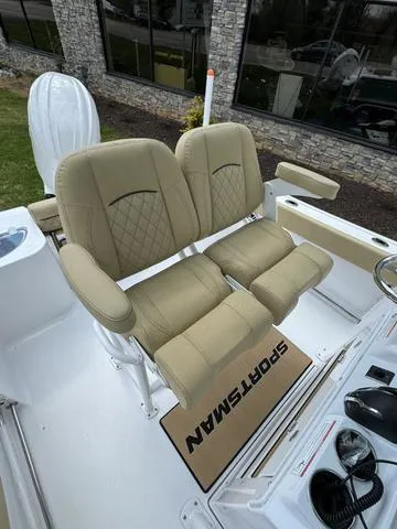 Slide: The Image of 2024 Sportsman Open 212 boat with beige cushioned seats and modern design. - 5