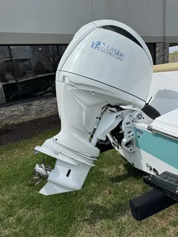 Slide: The Image of 2024 Sportsman Open 212 boat with Yamaha outboard motor, displayed outdoors. - 8