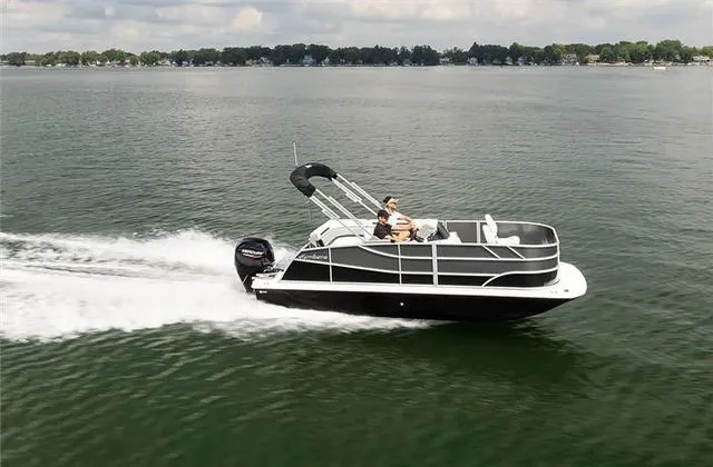 Slide: The Image of 2024 Hurricane FunDeck 1960 REF cruising on a lake under a cloudy sky. - 13