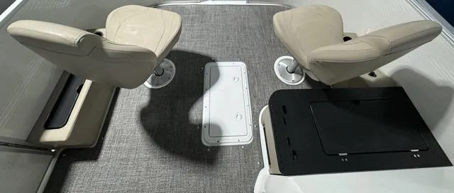 Slide: The Image of 2024 Hurricane FunDeck 1960 REF interior with two beige seats and gray carpet flooring. - 8