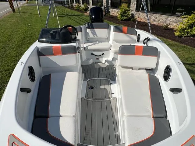 Slide: The Image of 2020 Tahoe T16 boat interior with gray and orange seating, steering console, and spacious layout. - 10