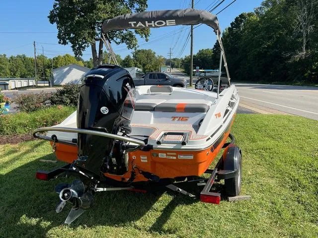 Slide: The Image of 2020 Tahoe T16 boat with outboard motor on trailer, parked on grass. - 5