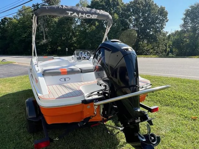 Slide: The Image of 2020 Tahoe T16 boat with outboard motor on grassy area, sunny day. - 6