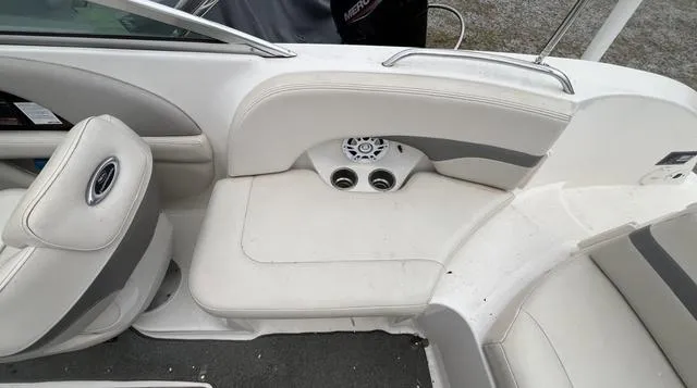Slide: The Image of 2005 Chaparral Sunesta 236 boat interior with white seating and speaker system. - 11