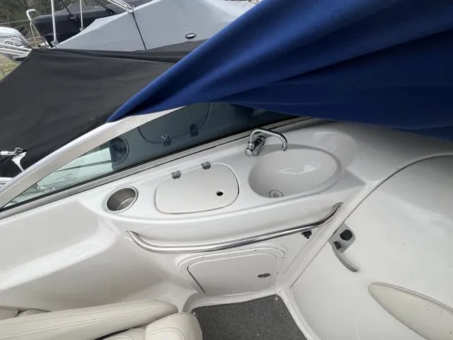 Slide: The Image of 2005 Chaparral Sunesta 236 boat interior with sink and seating area. - 14
