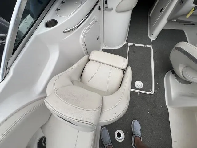 Slide: The Image of 2005 Chaparral Sunesta 236 boat interior with white seating and gray flooring. - 9