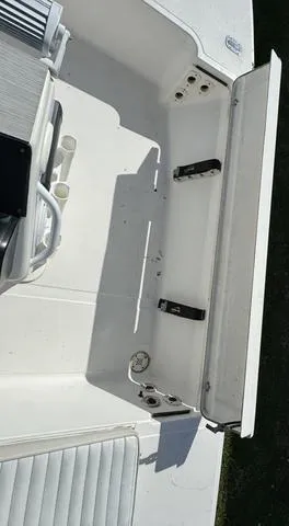 Slide: The Image of 2003 Sea Fox 180FF boat interior, featuring white seating and storage compartments. - 14