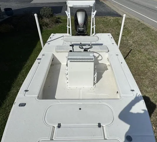 Slide: The Image of 2003 Sea Fox 180FF boat, white deck, center console, outboard motor, parked on grass. - 6