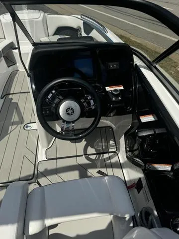Slide: The Image of 2022 Yamaha Boats 212XD cockpit with steering wheel and control panel. - 8
