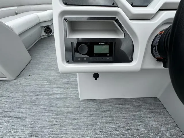 Slide: The Image of 2024 Godfrey Xperience 2286 SBX boat interior with audio system and seating. - 7